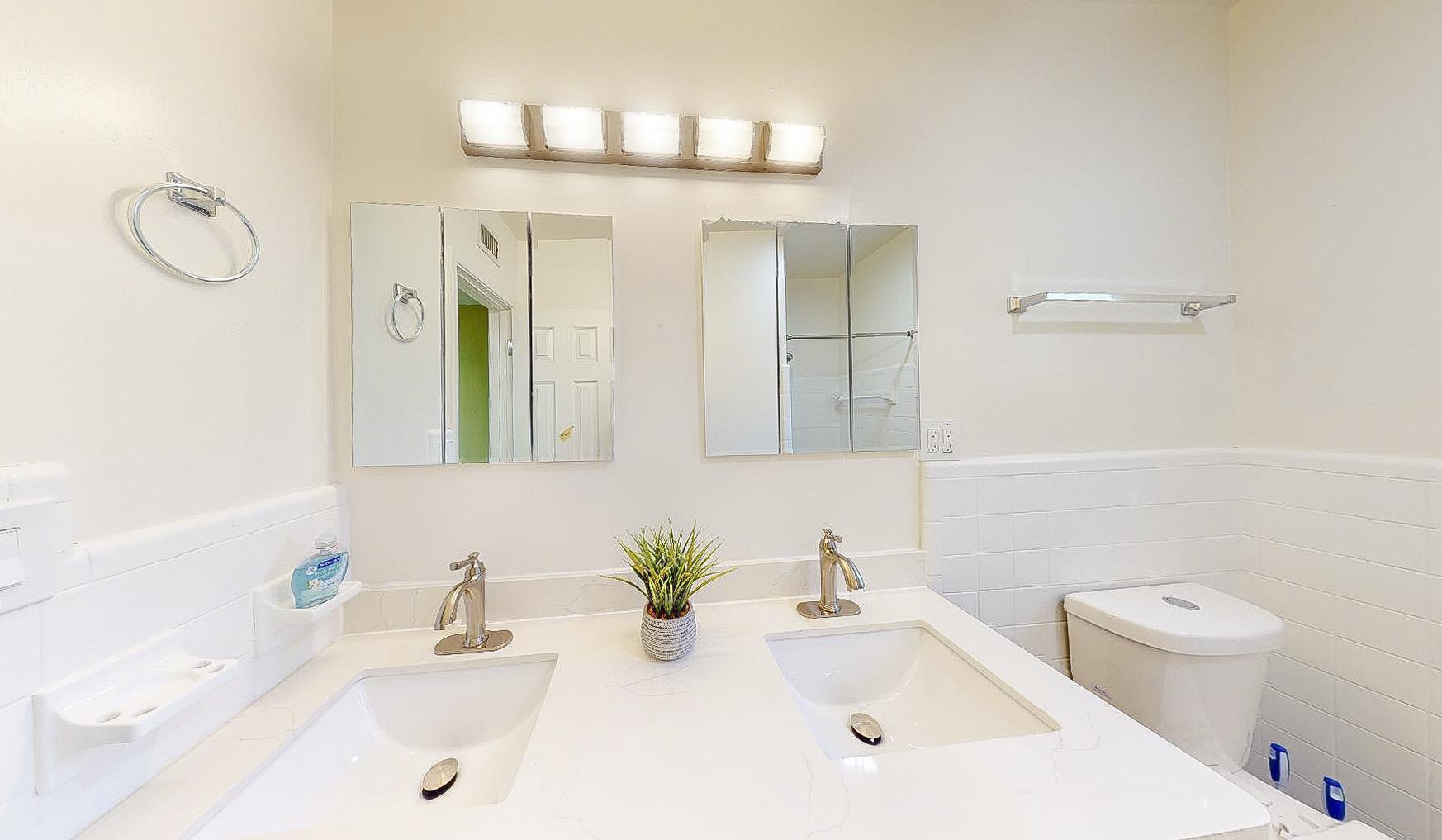 Bathroom with double sinks and storage in medicine cabinets