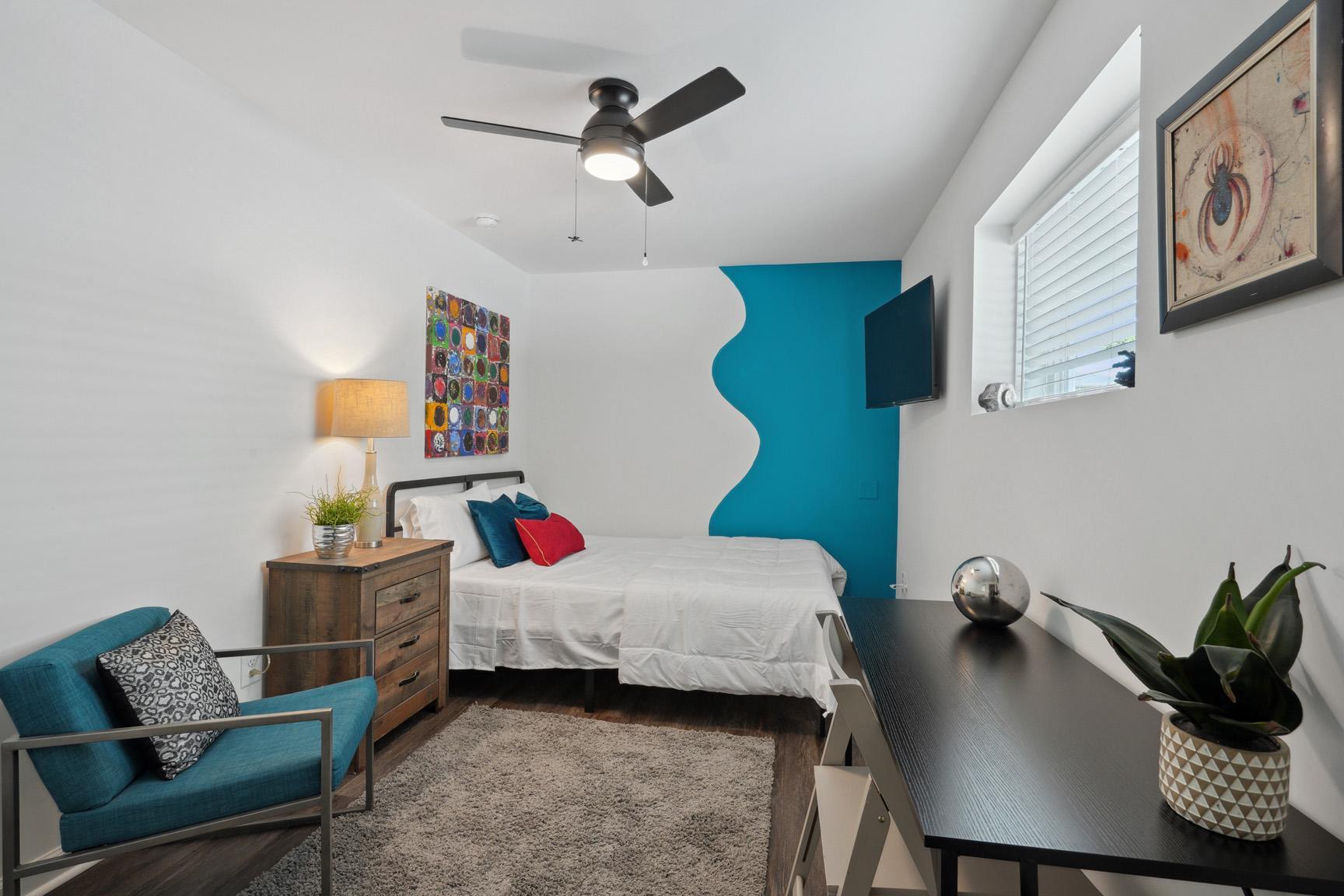 Includes a Queen Bed, Sitting Chair, Large TV and Work Desk