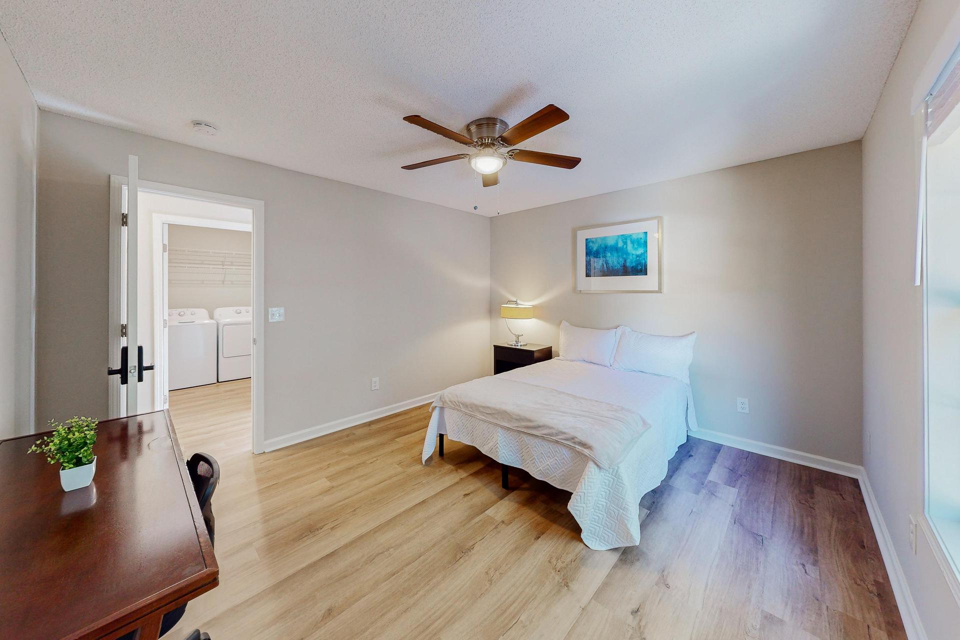 Private bedroom with Full size bed, nightstand, desk, ceiling fan and closet.