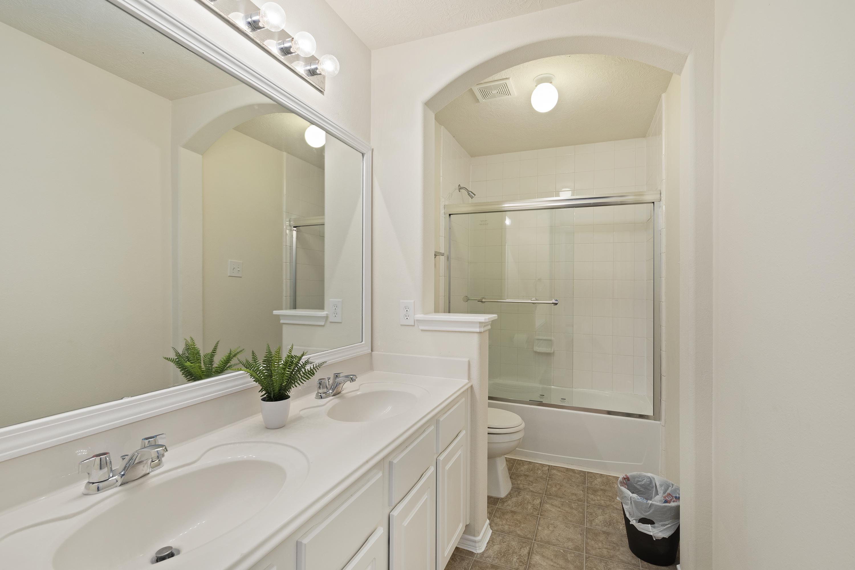 Double vanity is the standard for our royal tenants. This second bathroom has standup shower with tub