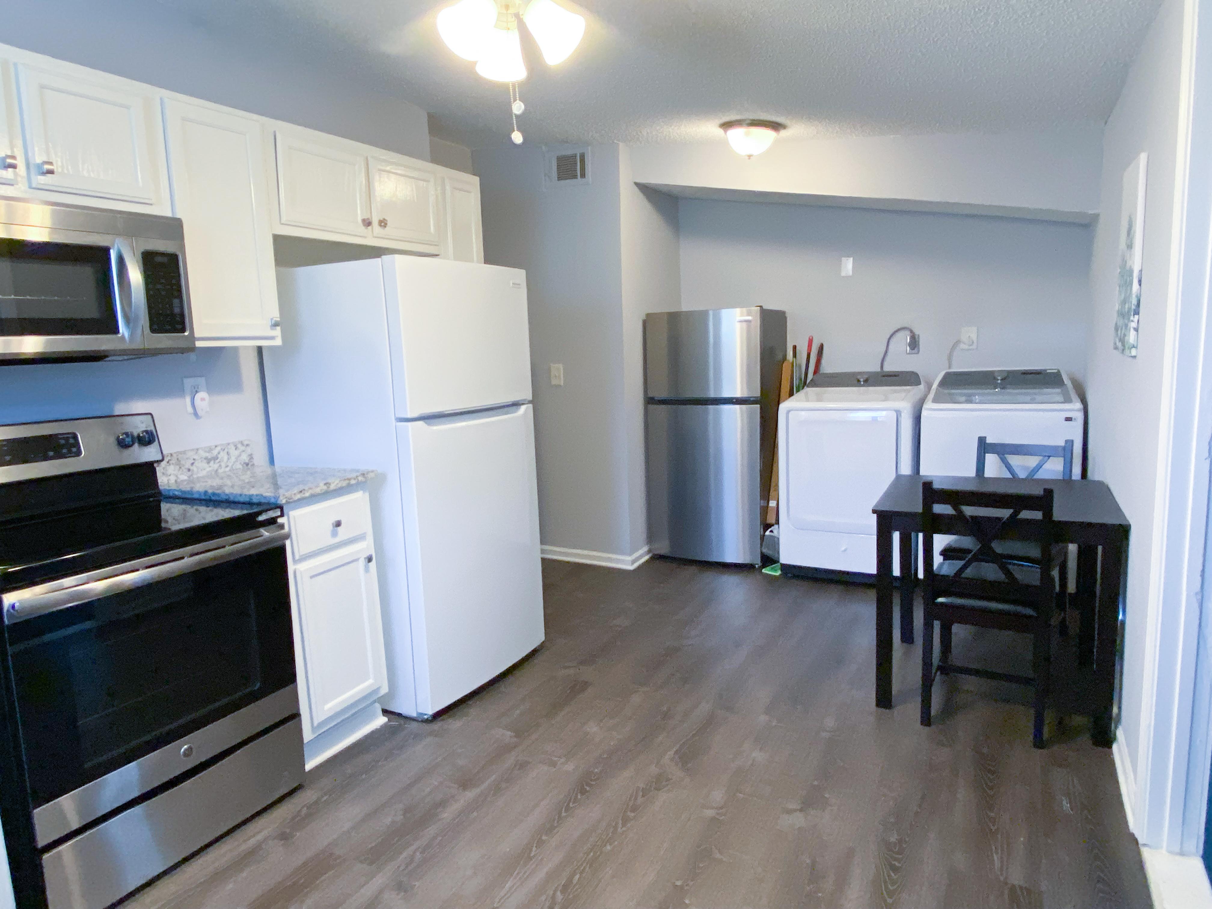 Shared Living Space with Dining Table, x2 Fridge, and Communal Washer/Dryer